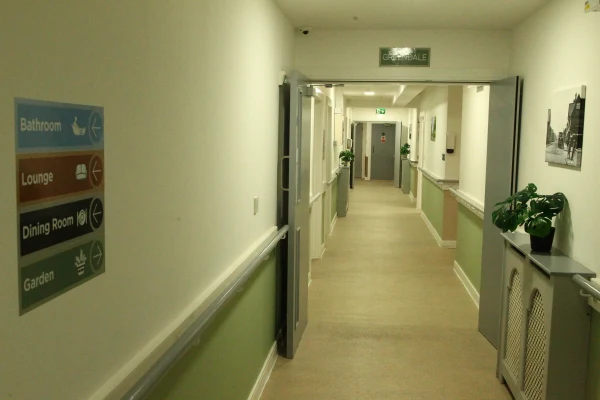 Accessible corridor with signage at Chestnut Rise Nursing Home